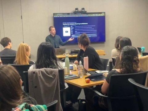 Mike leading an AI workshop with a group around a table